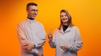 Two People Smiling Orange Background Image